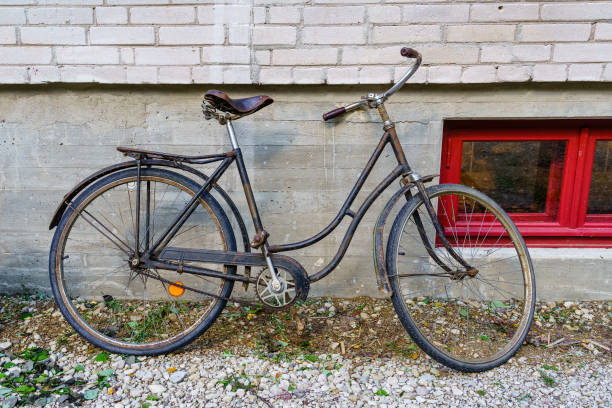 istock Old rusty bicycle parked on the wall of an old building. 1342088536