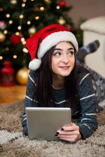 istock Young woman using digital tablet at Christmas time 1342088720