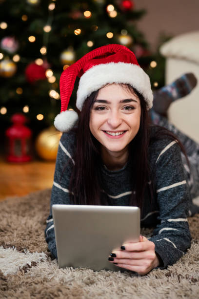 istock Young woman using digital tablet at Christmas time 1342088721
