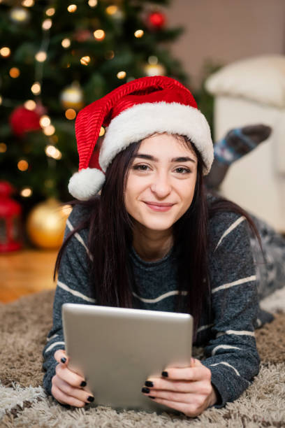 istock Young woman using digital tablet at Christmas time 1342088723