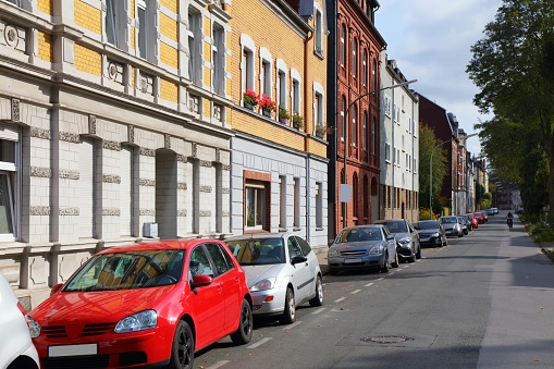 Gelsenkirchen city, Germany. Old residential street view. Street parking alongside curb.