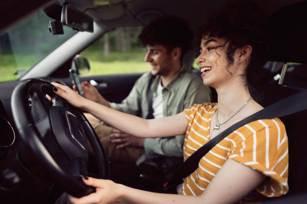 istock Smiling young couple navigating with smart phone on a road trip 1342093153