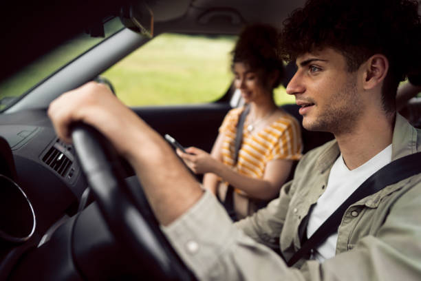 istock Couple navigating with smart phone on a road trip 1342093186