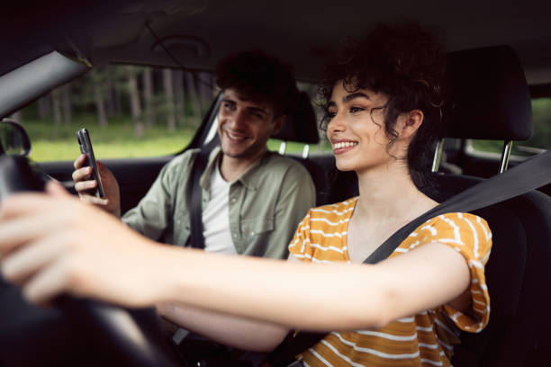 istock Cheerful young couple navigating with smart phone on a road trip 1342093190