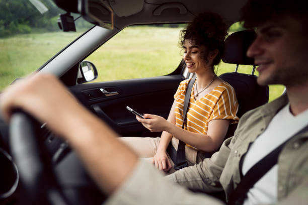 istock Man and woman navigating with smart phone on a road trip 1342093196