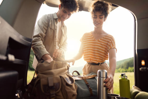 istock Young couple preparing their backpacks a for hike in the forest 1342093221