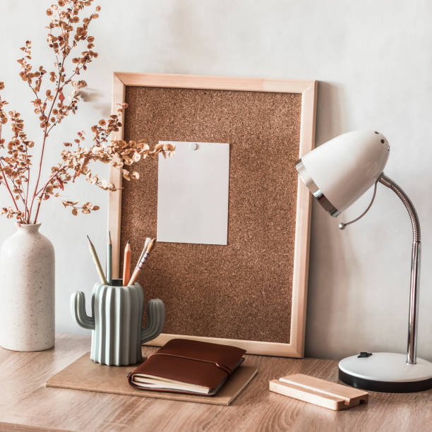istock Back to school. The student's working home place. A table with educational supplies, a cork board for notes, a table lamp, pencils and a decorative vase with dried flowers 1342093267