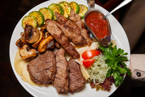 istock Beef lula kebab and shish kebab with grilled vegetables. Close-up, selective focus 1342094666