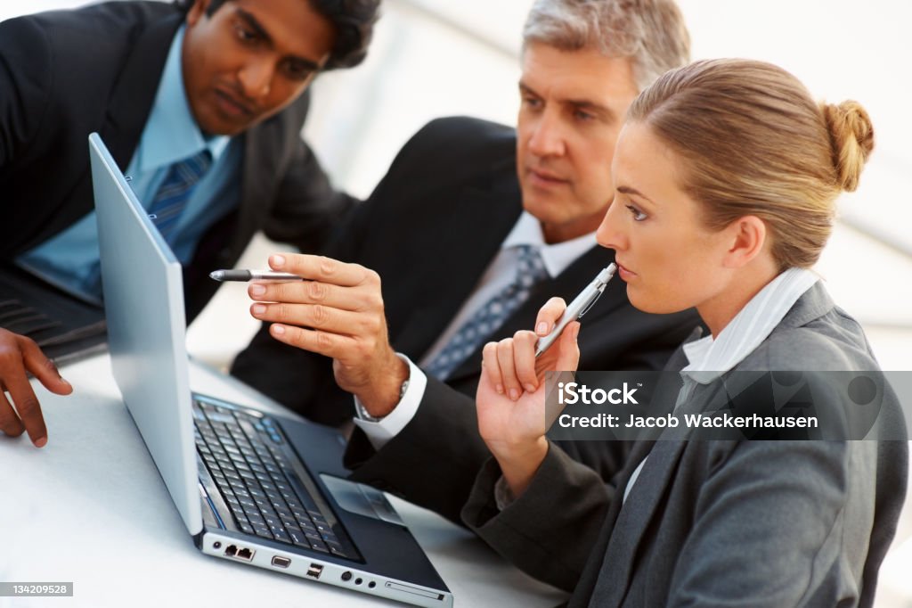 Business colleagues working on a laptop 20-24 Years Stock Photo