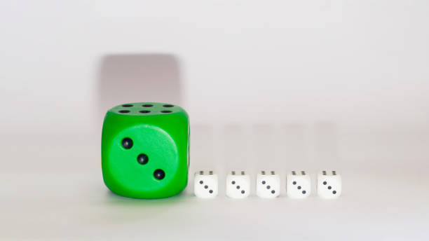 istock green dice next to white ones on a white background 1342096652