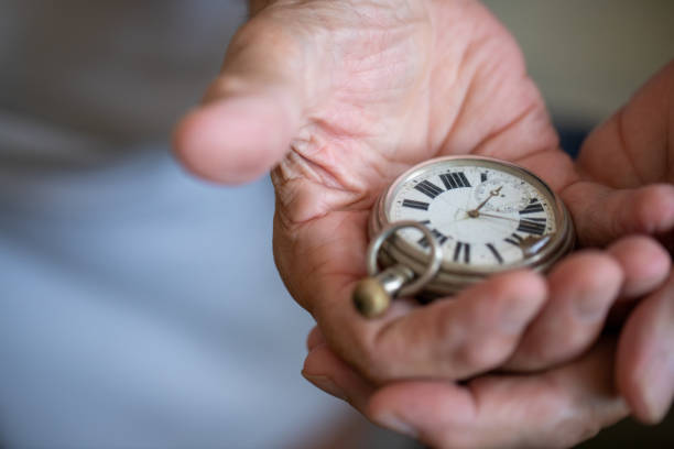 istock Old men holding very old watch in his hand 1342096700