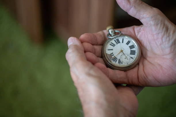 istock Old men holding very old watch in his hand 1342096747
