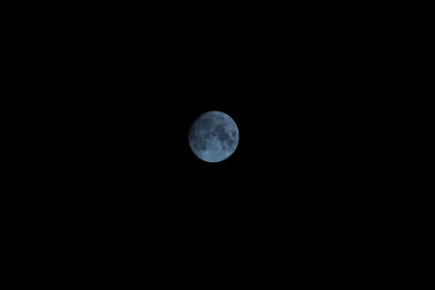 istock Beautiful Dark Silver Blue Moon On the Sky Midnight Black sky black background 1342098450