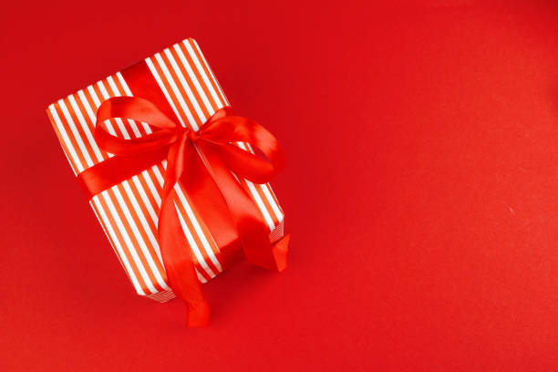 istock Wrapped gift box on a red background, view from above 1342098455