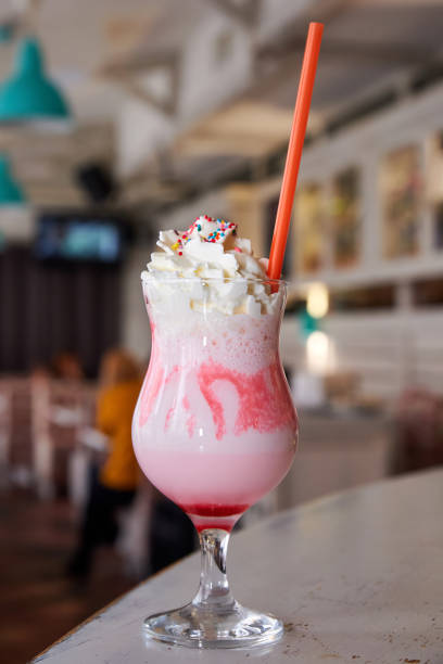 istock Cold sweet milkshake with red syrup and cream. Close-up, selective focus 1342100961