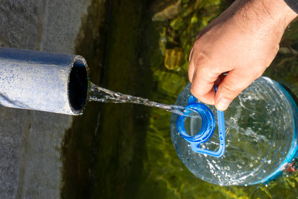 istock Fills natural spring water into the bottle 1342101441