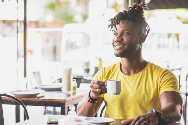 istock Man drinking a cup of coffee at a coffee shop. 1342101685