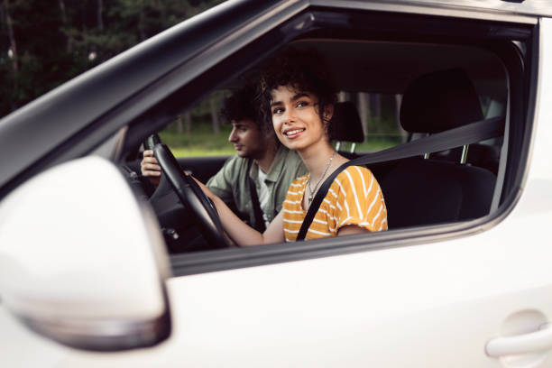 istock Happy couple navigating with smart phone on a road trip 1342102748