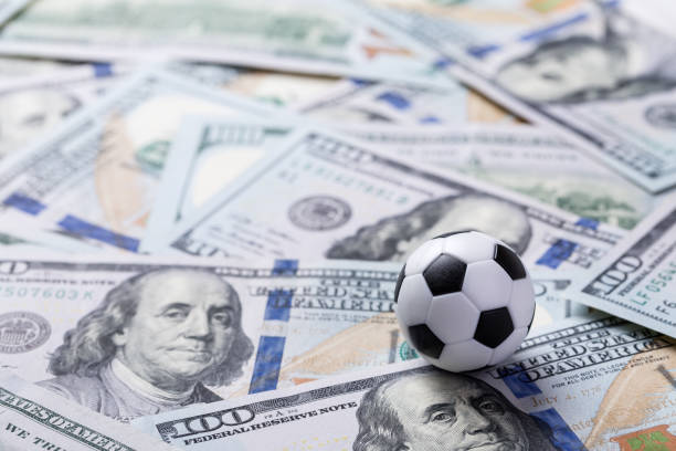 istock Soccer ball on dollar banknotes 1342104356