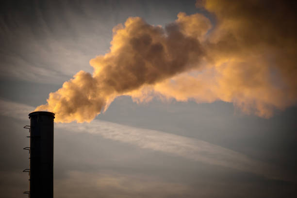 istock Industrial smoke from chimney on blue sky 1342109695