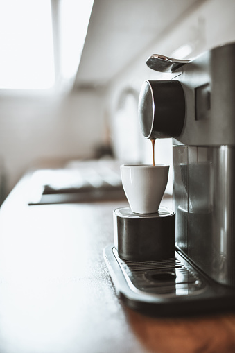 Espresso Machine Pouring Hot Coffee In Cup During Morning