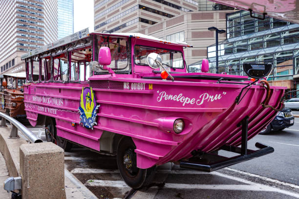 Boston, MA USA - An Amphibious Vehicle Used For The Popular Boston DUCK Tour Parked By The Sidewalk To Board Tourists For The Next Tour Boston MA, USA - September 06, 2011: The Penelope Pru, a Boston Duck Tours' DUKW Vehicle that is used to provide tourists and visitors with a sightseeing tour of Boston and the Charles River. The vehicle, a remanent of World War II transportation, is amphibious and can travel both on land and water. Image shot in the afternoon sunlight; horizontal format. Camera: Canon EOS 5D MII. Lens: Canon EF 24-70 mm F2.8L USM amphibious vehicle stock pictures, royalty-free photos & images