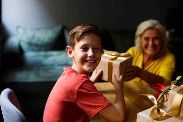 istock Cheerful boy, elementary age is getting New Year presents from his granny. 1342116003