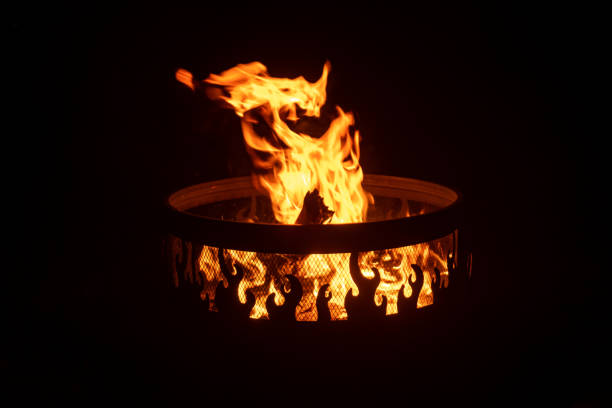 Side angle view of fire in an outdoor fire pit at night