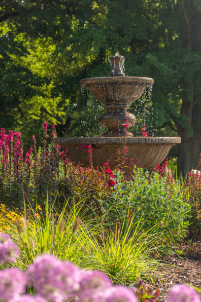 Garden fountain with flowers and grasses in foreground at Hershey Gardens