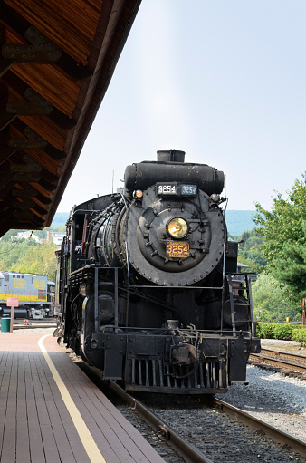Scranton, USA - September 1, 2011: Steam locomotive approaching passenger platform at Steamtown National Historic Site during one of a short train excursions.