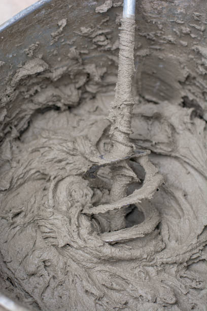 istock Mixing a plaster solution by an electric drill. Adhesive mixing. Home renovation. 1342117330