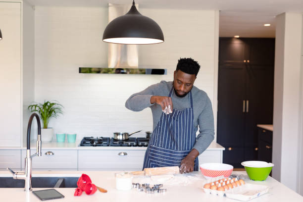 istock Focused african american man wearing apron, baking in kitchen 1342117541
