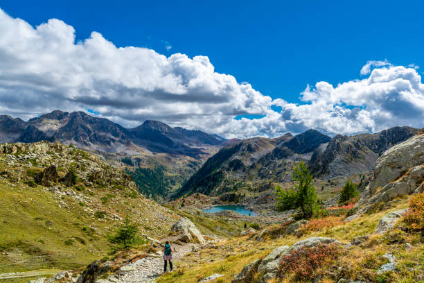 The first autumn colors at the Lakes of Sant'Anna di Vinadio in the upper Stura Valley (Province of Cuneo, Piedmont, Italy) The red color of the blueberry plants and the clouds on the horizon are the signs of the imminent arrival of autumn cuneo stock pictures, royalty-free photos & images