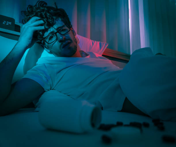istock tired caucasian male having stressed problem with sleeping pill medication for insomnia treatment. 1342117589