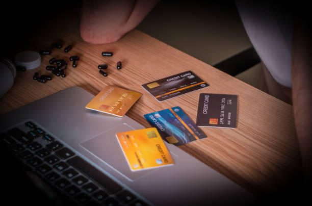caucasian male is tring to work out how to manage the credit cards over debt with stressed stock photo