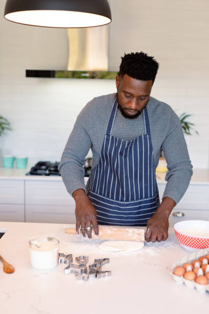 istock Focused african american man wearing apron, baking in kitchen 1342118707