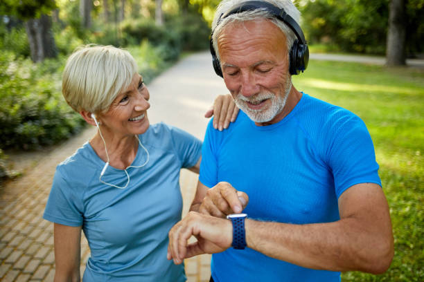 istock Senior couple using smart watch while exercising outdoors 1342119312