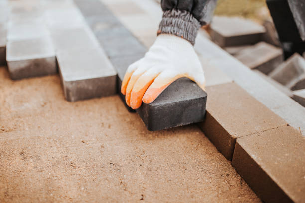 istock Professional bricklayer builder in the process of working on walls and walking path 1342119435