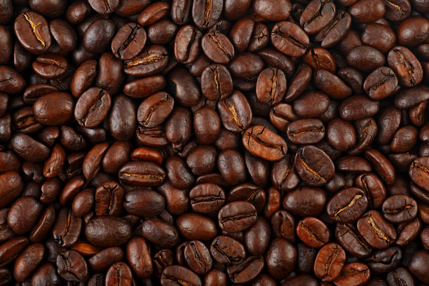 istock Roasted coffee beans as background, top view. Black coffee beans. 1342120040