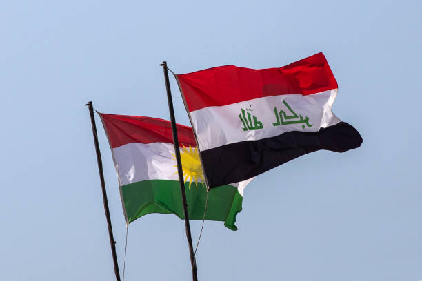 Flags of Iraq and the Autonomous Region of Iraqi Kurdistan. Flags of Iraq and the Autonomous Region of Iraqi Kurdistan on a background of blue sky. kurdistan stock pictures, royalty-free photos & images