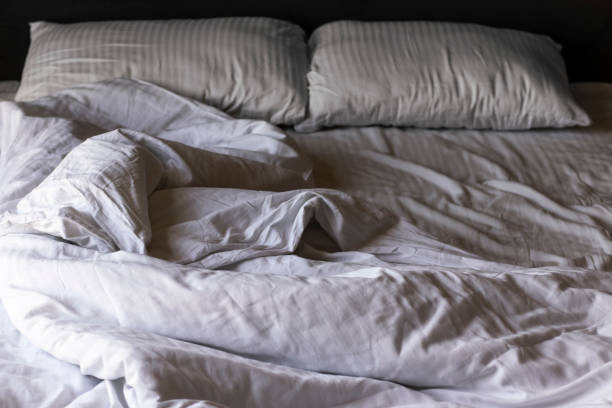 istock Empty bed with white crumpled linen in the morning. 1342120263