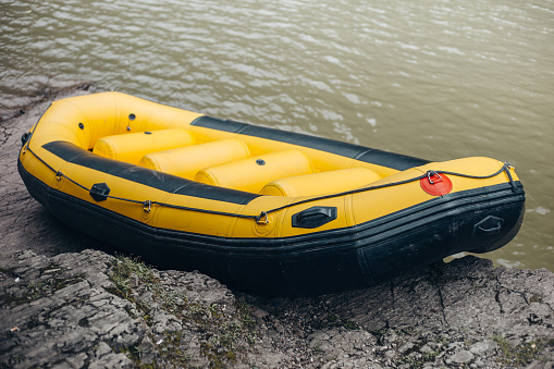Yellow inflatable rubber boat for active recreation on the river - amateur rafting