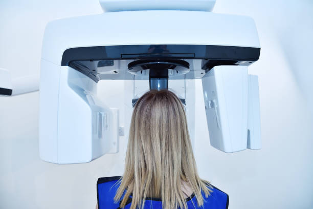 istock Woman patient make a x-ray picture on dental panoramic tomograph 1342121497