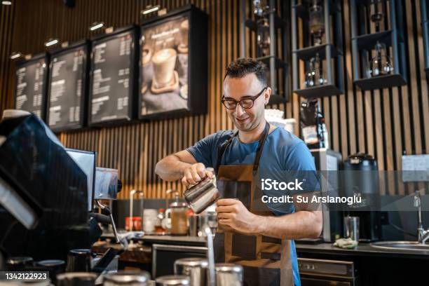 Male Barista Making Coffee For Customers At The Bar Stock Photo - Download Image Now