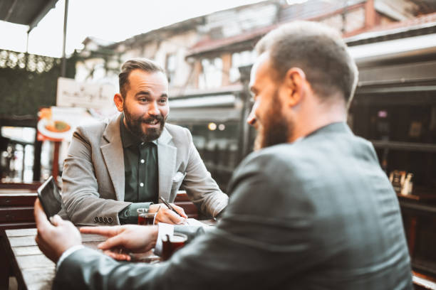 istock Smiling Businessmen Working During Tea Time Together 1342124156