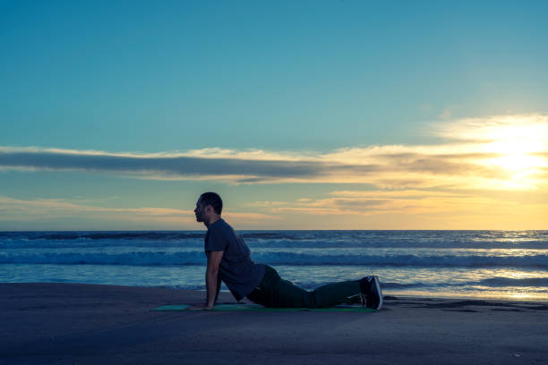 istock person on the beach doing yoga or exercise at beautiful sunset 1342124263