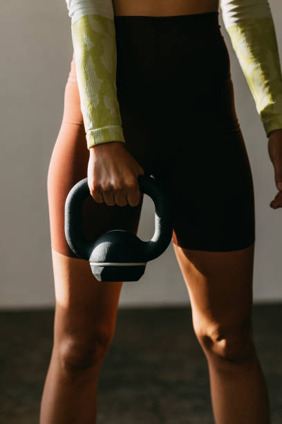 istock Unrecognizable Woman Exercising with Kettlebell Weights 1342124360