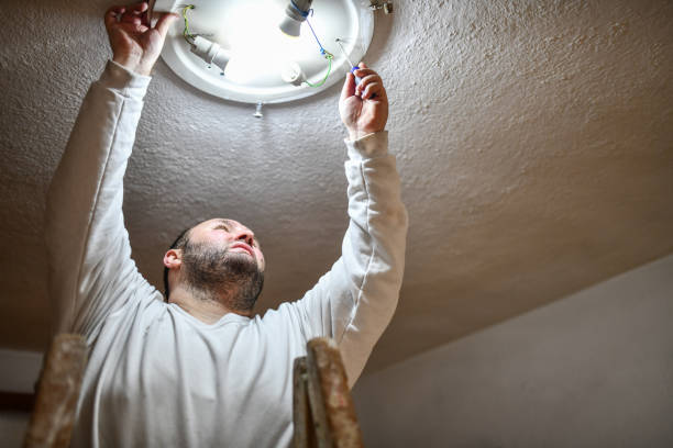 istock Bearded Balding Male Replacing Light Bulb 1342124750