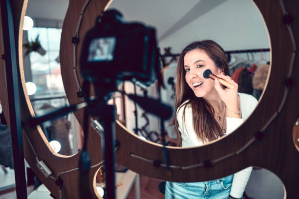 istock Beautiful Female Putting Makeup During Vlog 1342127176