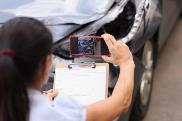 istock Insurance agent is filming damage to crashed car 1342127331